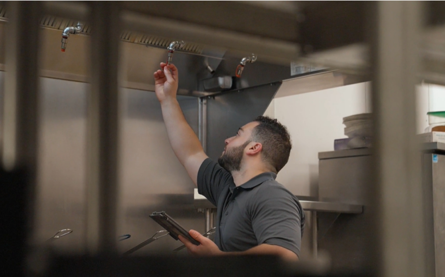 Technician servicing kitchen equipment